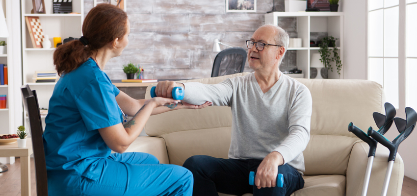 mobile physiotherapist with man doing rehab exercises
